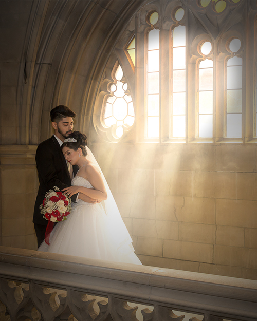 Wedding photoshoot of a bride in front of the arched windows at Knox College, Toronto.